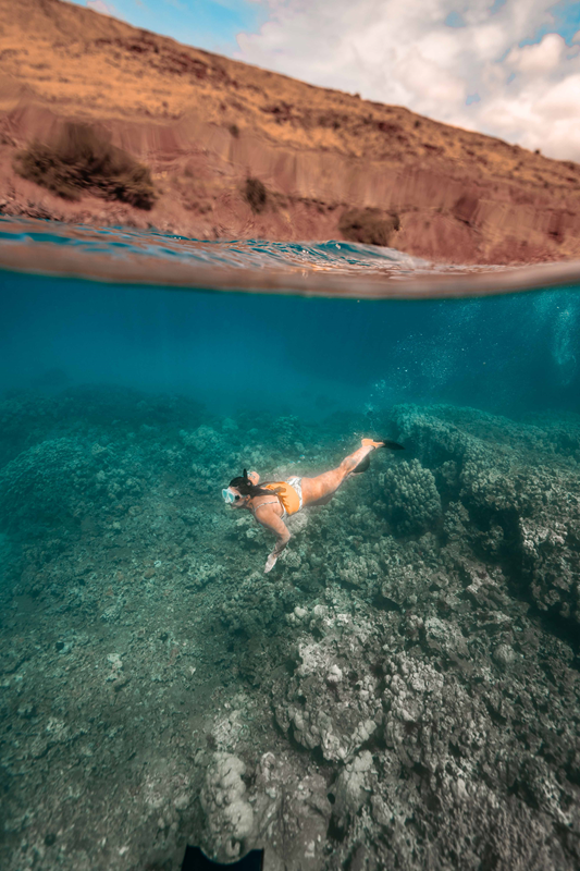 Molokini-Snorkeling-Morning-Tour Snorkeler gliding over shallow reef in clear morning water at Molokini