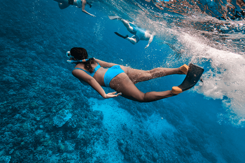 Woman snorkeling in clear blue water on a maui snorkeling tour Woman snorkeling in clear blue water on a maui snorkeling tour