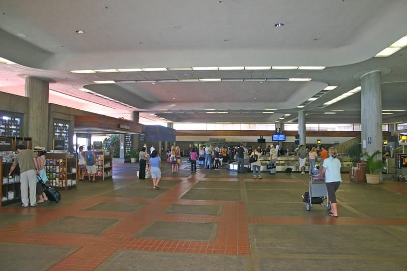 OGG airport terminal with travelers. OGG airport terminal with travelers.