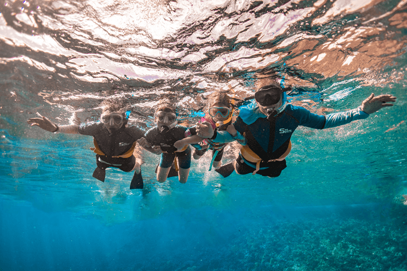 Snorkeling With Kids Family snorkeling in clear water on a Maui Snorkeling Tour