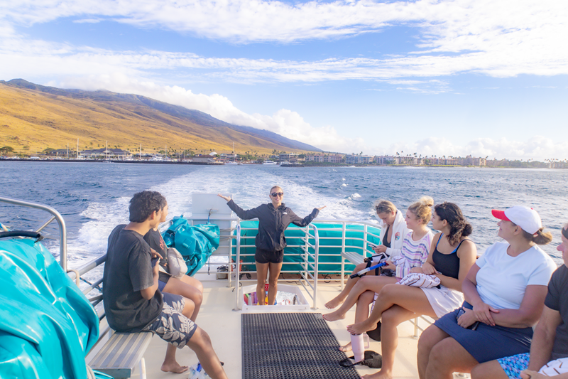 Crew member briefing seated guests aboard a Maui snorkeling tour boat